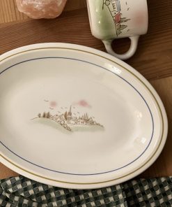 Plat ovale motif village